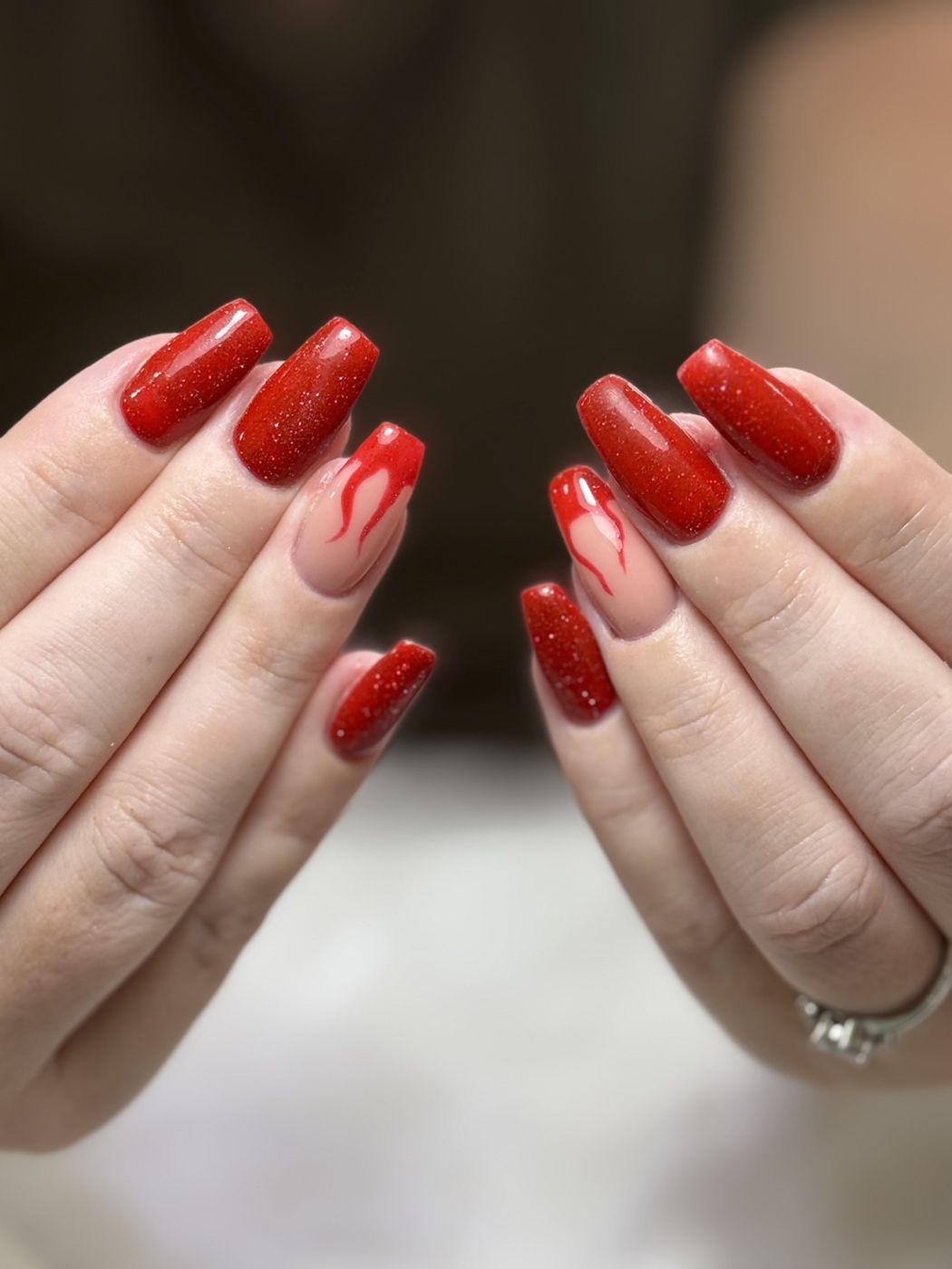 Red nails with hand-painted flame details
