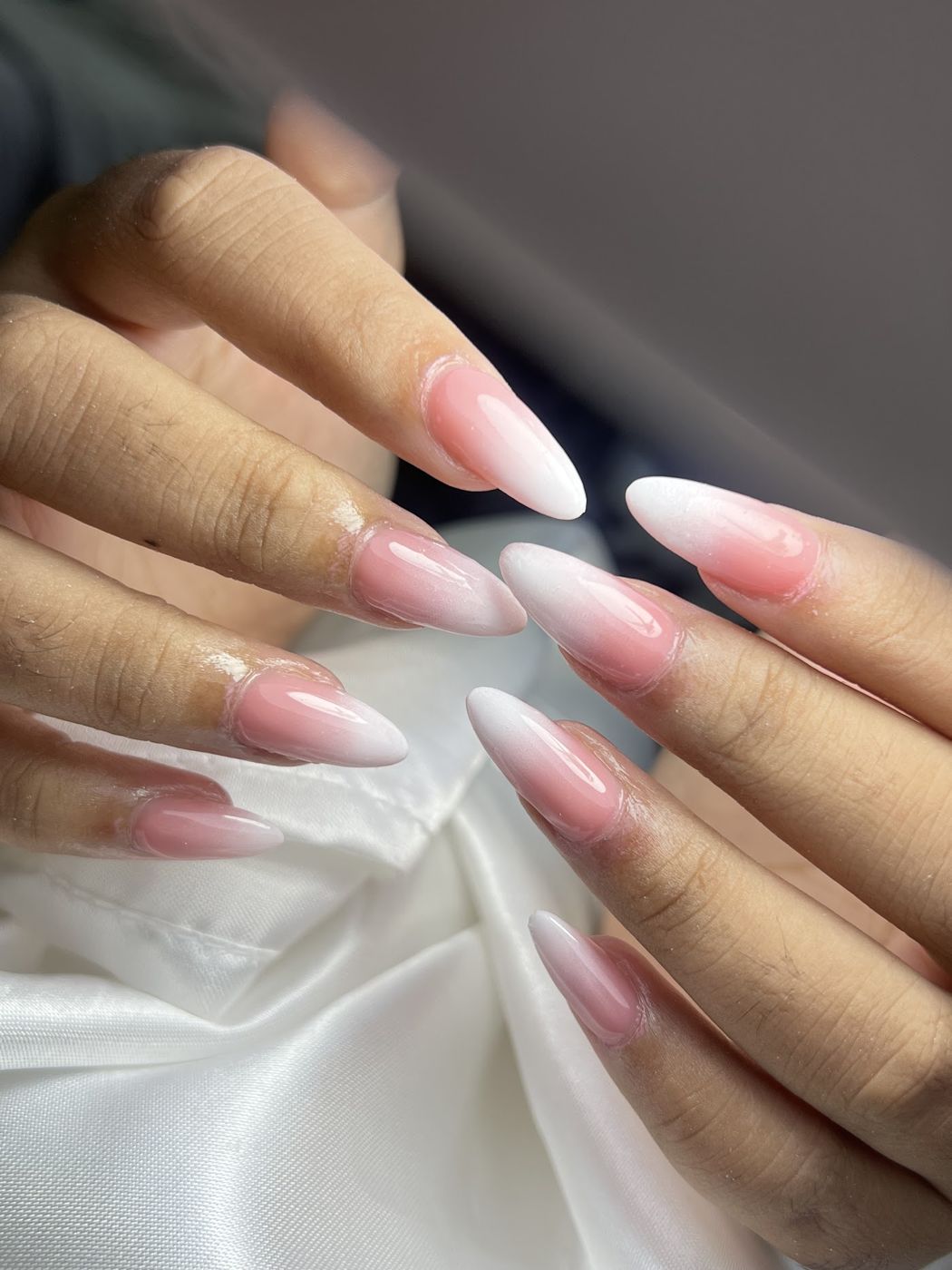 Soft almond nails with a pink and white ombre finish